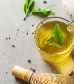Imagine de sus cu o cană de ceai verde, pe un fundal gri