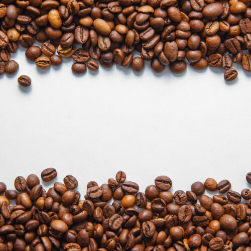 boabe de cafea insirate pe o masa alba