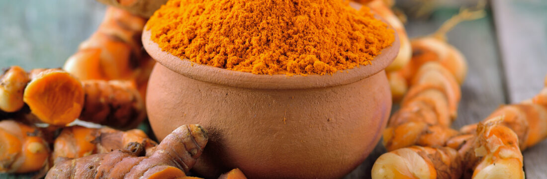 turmeric roots in the basket on wooden table
