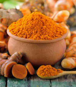 turmeric roots in the basket on wooden table