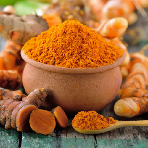 turmeric roots in the basket on wooden table
