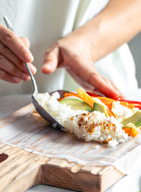 Mâna unei femei tinere care pregătește un preparat specific in dieta japoneza