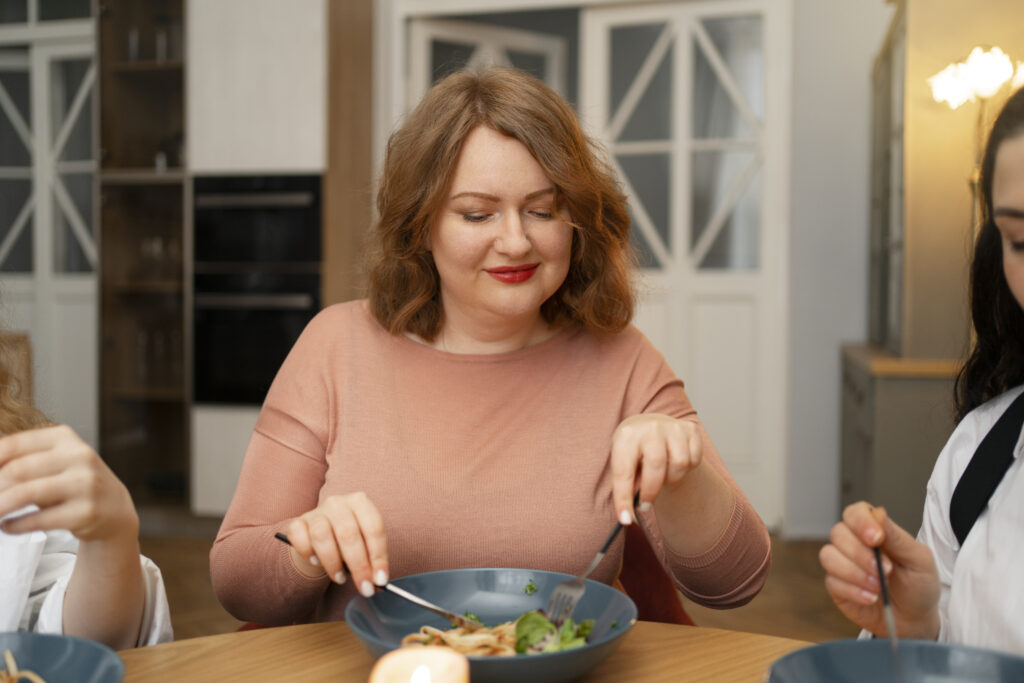 Imagine din față, femeie care mănâncă un preparat ușor din dieta Cambridge